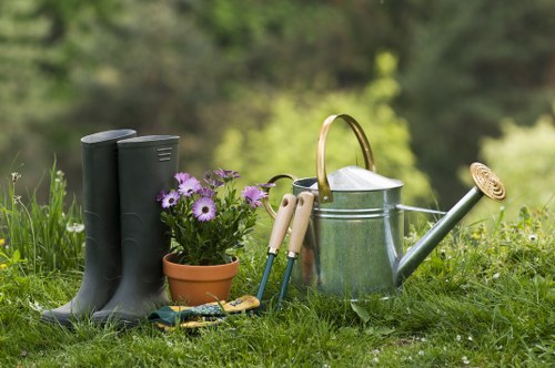 Professional gardener starting work in a Hoxton garden with tools and plan
